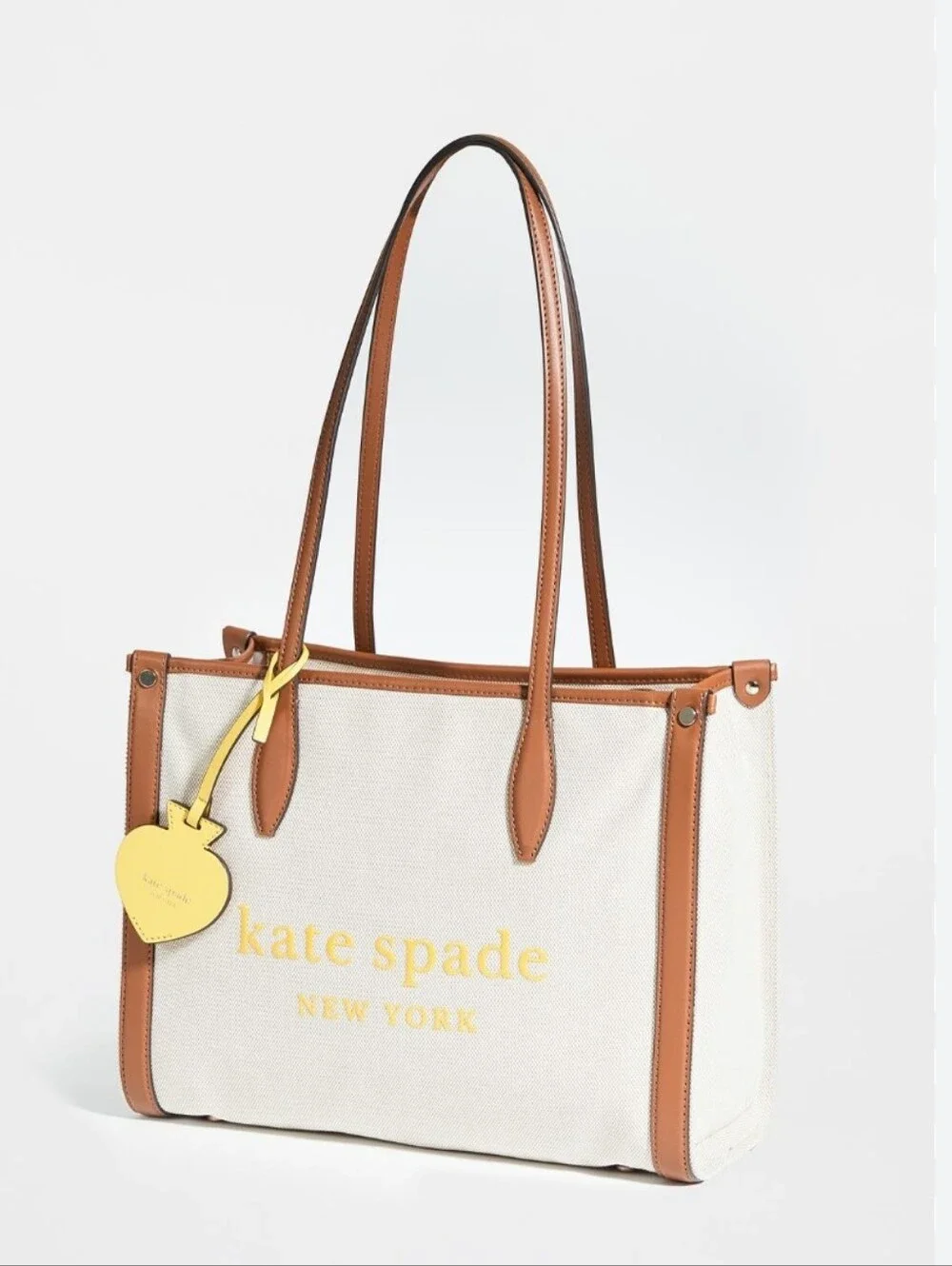 kate spade Beige Canvas Tote with Brown Trim and Yellow Charm